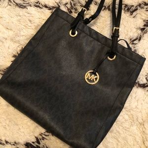 MICHAEL KORS slender, black tote with gold accents